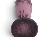 a purple vase sitting on top of a white table