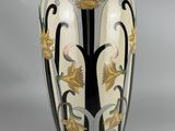 a vase that has a black and white design on it