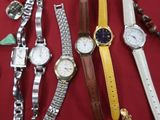 many different types of watches and bracelets on a table