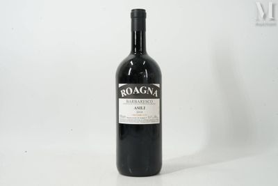 the bottle of red wine is sitting on a white surface