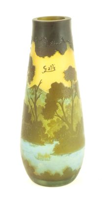 a vase with a painting on it sitting on a table