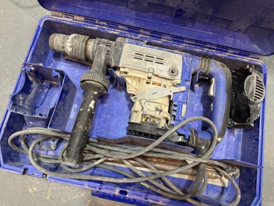 une boîte à outils bleue contenant une perceuse et d'autres outils