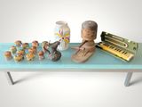 a blue table with a piano, vases, and other items on it