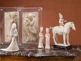 a statue of a man riding a horse next to a group of statues