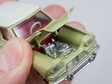 a person holding a toy car in their hand