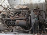 an old engine in the back of an old truck