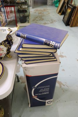 une pile de livres posée sur une table, à côté d'un bol