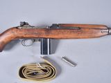 a close up of a rifle with a wooden handle and a rope