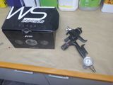 a box with a gun and a gauge sitting on a table