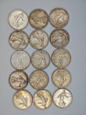 a bunch of silver coins sitting on top of a white surface