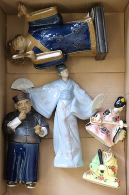 many figurines in a box that are in the shape of people