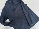 the jacket is black and has buttons on the collar
