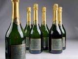 six bottles of champagne are lined up in a row