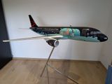 a model of a plane on a stand in a room