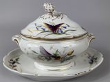 a bowl and saucer on a plate with a butterfly on it