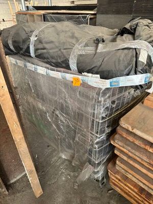 a bed that is wrapped in plastic and sitting on a pallet