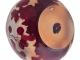 a glass ball with a red and white design on it