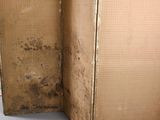 a brown box with a black handle sitting on a white surface