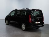 the small black van is parked in a large room