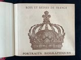 an open book with a crown on top of it sitting on a table