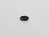 an oval blue sapphire stone on a white surface