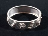 a close up of a silver ring on a black surface