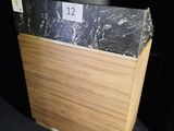 a wooden box with a black marble top on a table