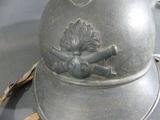 a silver helmet with a bird on it on a table