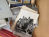 a box full of old postcards and envelopes sitting on a table