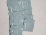four packets of blue packets of toothpaste sitting on a table