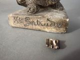 a statue of a dog sitting on top of a book