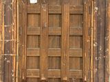 an old wooden frame with a window and a sticker on it