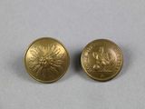 two gold colored buttons with a picture of a sun on them