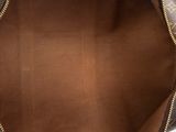 the inside of a brown louis vuitton bag on a white surface