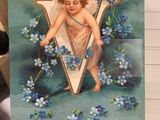 a card with a picture of an angel holding a letter v