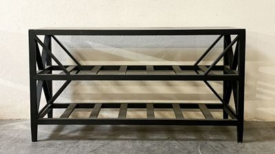 a black metal shelf with three shelves on it