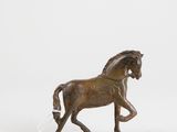 bronze statue of a horse with a long mane and tail