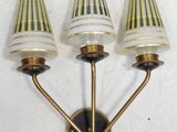 three light wall sconce with three lamps on each of them