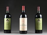 three bottles of wine are lined up on a table