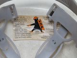 a label on a toilet seat with a picture of a man in a hat