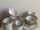 many cups and saucers sitting on a table