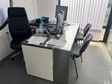 a desk with a chair and a computer on it