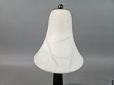 marbled glass table lamp with a black base and a white shade