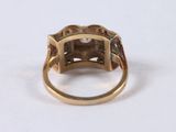 a close up of a gold ring with a diamond on it