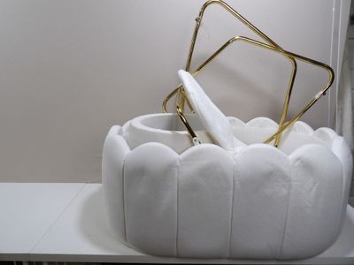 a white chair with a gold frame on top of it