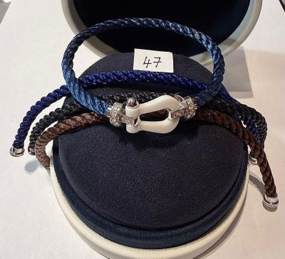 three bracelets that are sitting on top of a case