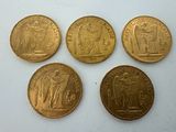 four gold sovereigns, one of which is a woman and one of which is a man
