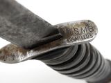 a close up of a metal object with a knife in it