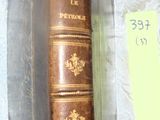an old book sitting on top of a table next to a glass case