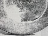 a black and white photo of a plate with writing on it